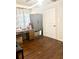 A versatile room with dark wood floors, featuring a sewing machine, storage cabinet, and natural light at 212 Austin Ne Ave, Marietta, GA 30060