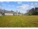 Expansive backyard features a well-maintained lawn and access to the home's exterior, perfect for outdoor activities at 331 Cobblestone Rd, Auburn, GA 30011