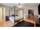 Bedroom featuring a striking black canopy bed frame, a closet, and dark accents at 331 Cobblestone Rd, Auburn, GA 30011