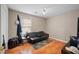 Simple bedroom featuring a futon sofa, a window, and neutral-colored walls at 331 Cobblestone Rd, Auburn, GA 30011