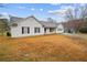 Side view of a quaint single-story home, featuring white siding and an expansive front yard at 331 Cobblestone Rd, Auburn, GA 30011