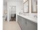 Well-lit bathroom with double sink vanity, and a view of a walk-in closet at 1080 Peachtree Ne St # 1902, Atlanta, GA 30309