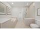 Bright bathroom features a soaking tub and glass enclosed shower at 1080 Peachtree Ne St # 1902, Atlanta, GA 30309