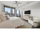 Spacious bedroom with a sitting area, dresser, ceiling fan and big windows with city views at 1080 Peachtree Ne St # 1902, Atlanta, GA 30309