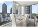 Bright dining room features city views from expansive windows and contemporary furnishings at 1080 Peachtree Ne St # 1902, Atlanta, GA 30309