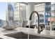 Close up view of a sink and faucet on a kitchen island with white quartz countertop at 1080 Peachtree Ne St # 1902, Atlanta, GA 30309