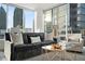 Elegant living room filled with natural light features comfortable seating and city views at 1080 Peachtree Ne St # 1902, Atlanta, GA 30309