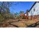 Backyard with elevated wooden deck accessible by stairs, with brick foundation at 160 Pine Grove Dr, Canton, GA 30114