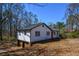 Home with basement garage and red front door, nestled in a partially wooded lot at 160 Pine Grove Dr, Canton, GA 30114