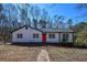 Charming single-story home with a vibrant red front door and a well-maintained yard at 160 Pine Grove Dr, Canton, GA 30114