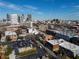 Panoramic aerial view of a city neighborhood featuring varied buildings, parking lots, and a modern downtown skyline at 204 Walker Sw St # 208, Atlanta, GA 30313