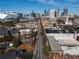 City neighborhood aerial view showing streets lined with buildings and the downtown skyline on the horizon at 204 Walker Sw St # 208, Atlanta, GA 30313