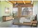 Modern bedroom featuring exposed brick wall and ceiling beams, bathed in natural light at 204 Walker Sw St # 208, Atlanta, GA 30313