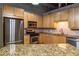 Modern kitchen with granite countertops, stainless appliances, and wood cabinetry at 204 Walker Sw St # 208, Atlanta, GA 30313