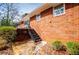 Brick home exterior showcasing a patio, stone feature, and stairs to the backyard at 2191 Sweetwater Ln, Austell, GA 30106