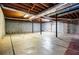 Unfinished basement with concrete floor, exposed wood ceiling, and black support beams at 2191 Sweetwater Ln, Austell, GA 30106