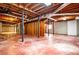 Unfinished basement with concrete floors, exposed ceiling, and support beams for customization at 2191 Sweetwater Ln, Austell, GA 30106