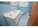 Bathroom featuring blue tile, white vanity, and a shower-tub combination at 2191 Sweetwater Ln, Austell, GA 30106