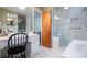 Bright bathroom featuring a walk-in shower with white tile and a vanity with a makeup desk at 2191 Sweetwater Ln, Austell, GA 30106