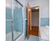 Bright bathroom with a glass shower, white sink, and blue tile details adds vintage charm at 2191 Sweetwater Ln, Austell, GA 30106