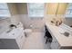 Well-lit bathroom with white tile flooring, a toilet, and a vanity with a full-length mirror at 2191 Sweetwater Ln, Austell, GA 30106