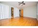 Spacious bedroom featuring hardwood floors, closet, and a ceiling fan at 2191 Sweetwater Ln, Austell, GA 30106