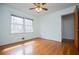 Sunlit bedroom with hardwood floors and large windows showcasing the outdoor view at 2191 Sweetwater Ln, Austell, GA 30106