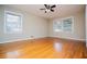 Spacious bedroom featuring hardwood floors, a ceiling fan, and large windows at 2191 Sweetwater Ln, Austell, GA 30106