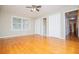 Expansive bedroom with hardwood floors, a ceiling fan, and natural light from the large window at 2191 Sweetwater Ln, Austell, GA 30106