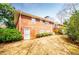 The exterior of a brick building with a white door and many windows at 2191 Sweetwater Ln, Austell, GA 30106