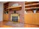 Close-up of a fireplace with red brick and wooden built-in bookshelves on each side of it at 2191 Sweetwater Ln, Austell, GA 30106