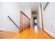 Bright upstairs hallway with hardwood floors and a wooden railing at 2191 Sweetwater Ln, Austell, GA 30106