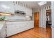 Traditional kitchen featuring white cabinetry, hardwood floors, and granite countertops at 2191 Sweetwater Ln, Austell, GA 30106