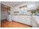 Cozy kitchen featuring white cabinetry, stainless steel appliances and hardwood flooring at 2191 Sweetwater Ln, Austell, GA 30106