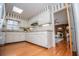 Bright kitchen with white cabinets, granite counters, and a charming floral wallpaper accent at 2191 Sweetwater Ln, Austell, GA 30106