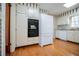 Classic kitchen with white cabinets, black built-in appliances, and sleek hardwood floors at 2191 Sweetwater Ln, Austell, GA 30106