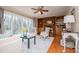 Bright living room featuring hardwood floors, large windows with patio view, and built-in shelving at 2191 Sweetwater Ln, Austell, GA 30106