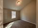 Bedroom features neutral walls, carpeting, and a window for natural light at 494 West Ave, Bowdon, GA 30108