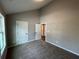 Bright bedroom featuring neutral walls, plush carpeting, and white doors, creating a calming atmosphere at 494 West Ave, Bowdon, GA 30108