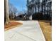 Long concrete driveway leading up to a charming single-Gathering home at 494 West Ave, Bowdon, GA 30108