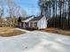 Exterior view with a long concrete driveway leading to a well-maintained home at 494 West Ave, Bowdon, GA 30108