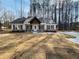 Inviting home featuring a spacious front yard and a welcoming facade at 494 West Ave, Bowdon, GA 30108