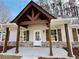 Charming front porch with rustic wood beams and stone accents at 494 West Ave, Bowdon, GA 30108