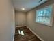 Functional laundry room with wood-look flooring and a bright window at 494 West Ave, Bowdon, GA 30108