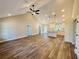 Open-concept living room and kitchen area with wood-look floors and vaulted ceiling at 494 West Ave, Bowdon, GA 30108