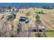 Expansive aerial view of a countryside home with outbuildings and fenced pasture at 5692 Rock Patch Rd, Loganville, GA 30052