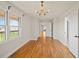 Bright bedroom featuring hardwood floors, a modern chandelier, and expansive windows overlooking the outdoors at 5692 Rock Patch Rd, Loganville, GA 30052