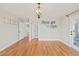 Well-lit bedroom with hardwood floors, modern chandelier, and multiple doorways at 5692 Rock Patch Rd, Loganville, GA 30052