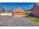 Side view of the brick garage and the side of the home, connected by a covered walkway at 5692 Rock Patch Rd, Loganville, GA 30052