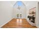 Bright living area with a vaulted ceiling, painted brick fireplace, and gleaming hardwood floors at 5692 Rock Patch Rd, Loganville, GA 30052